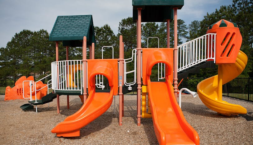 Orange and yellow playground slides and structures