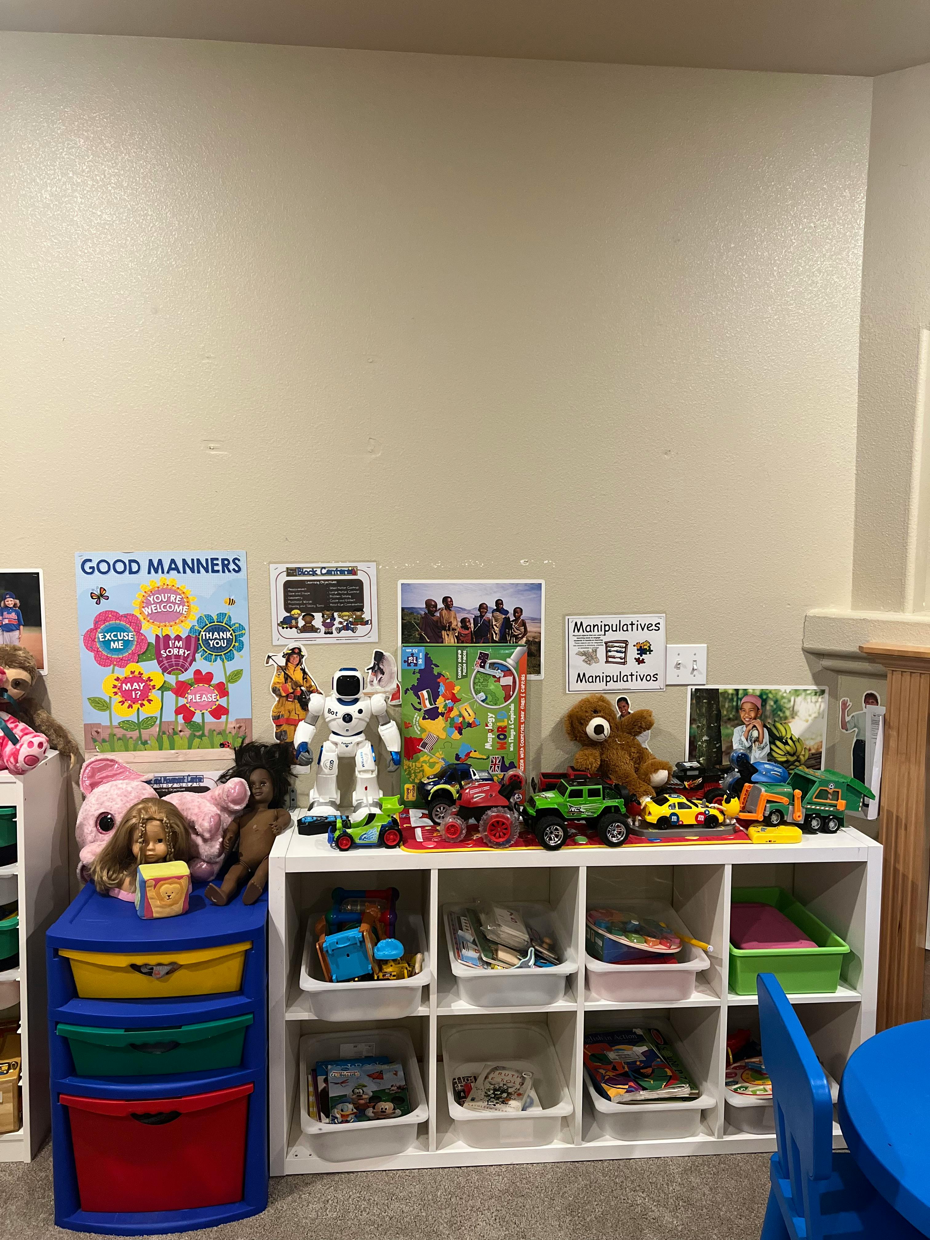 Shelves with toys, including stuffed animals, dolls, and toy vehicles