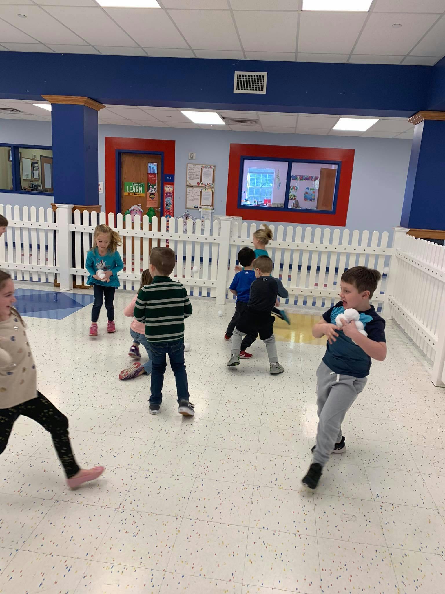 Children playing indoors with white objects