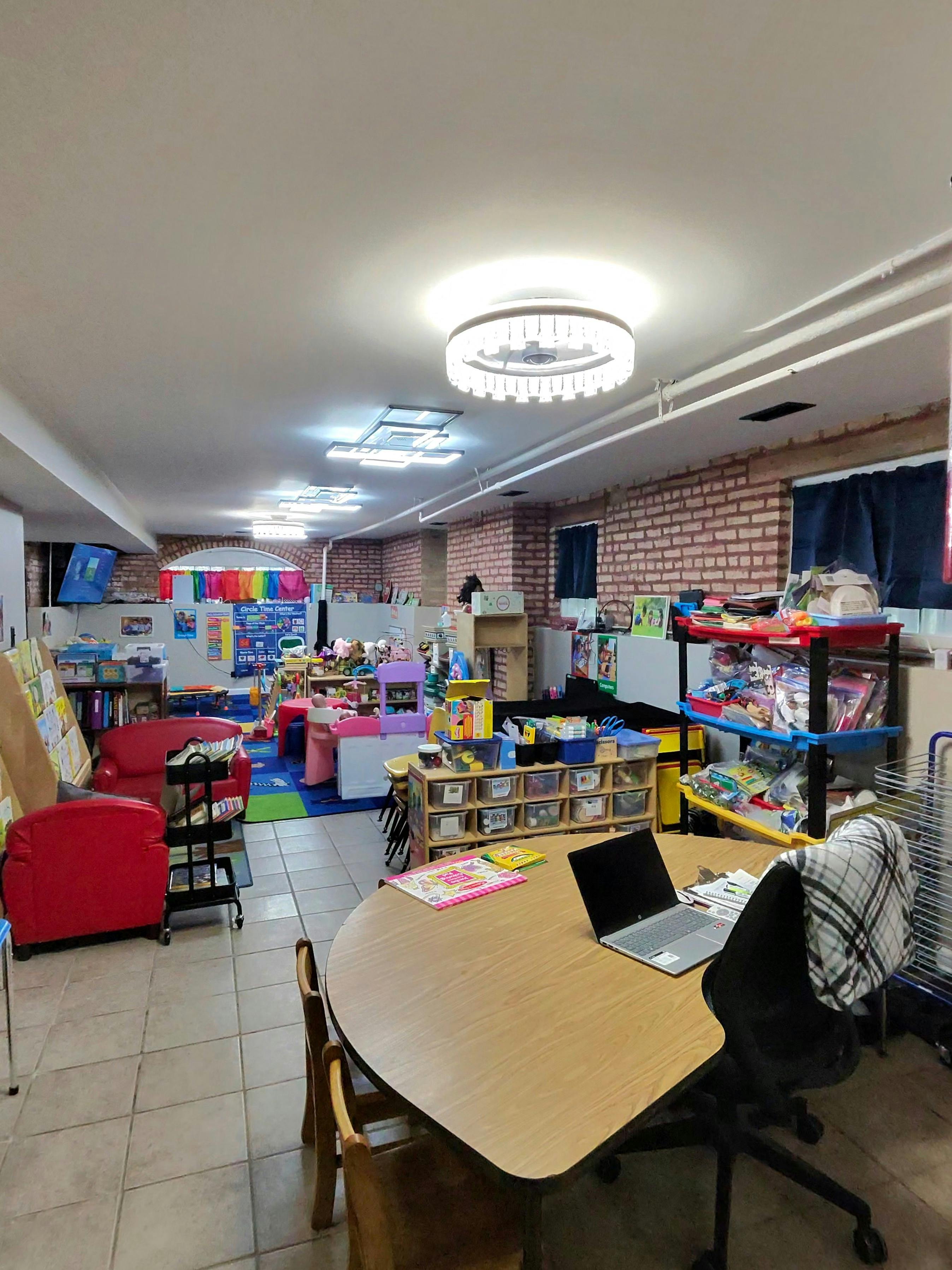 Classroom or daycare space with tables, storage, and educational toys