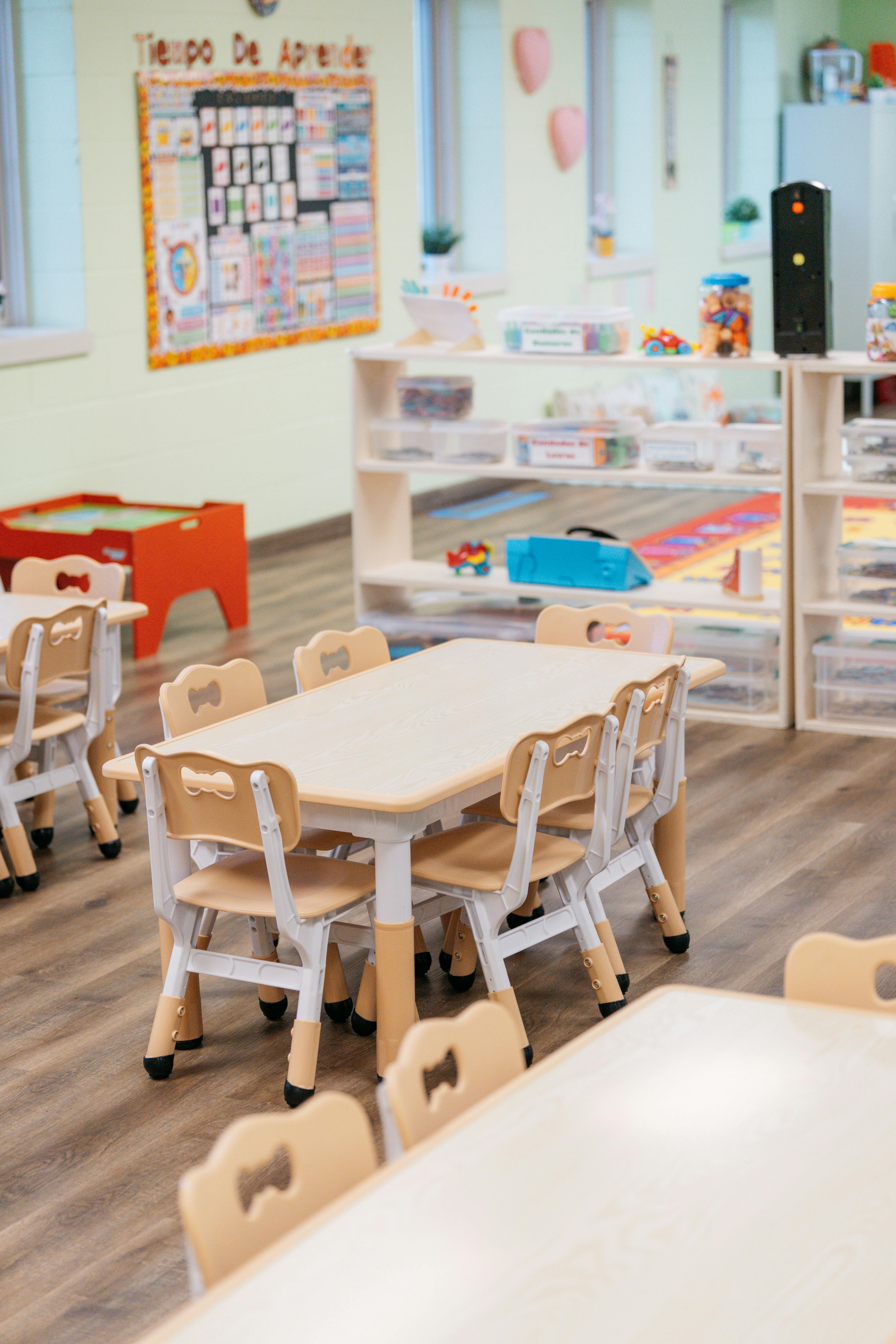 Empty classroom with small tables and chairs