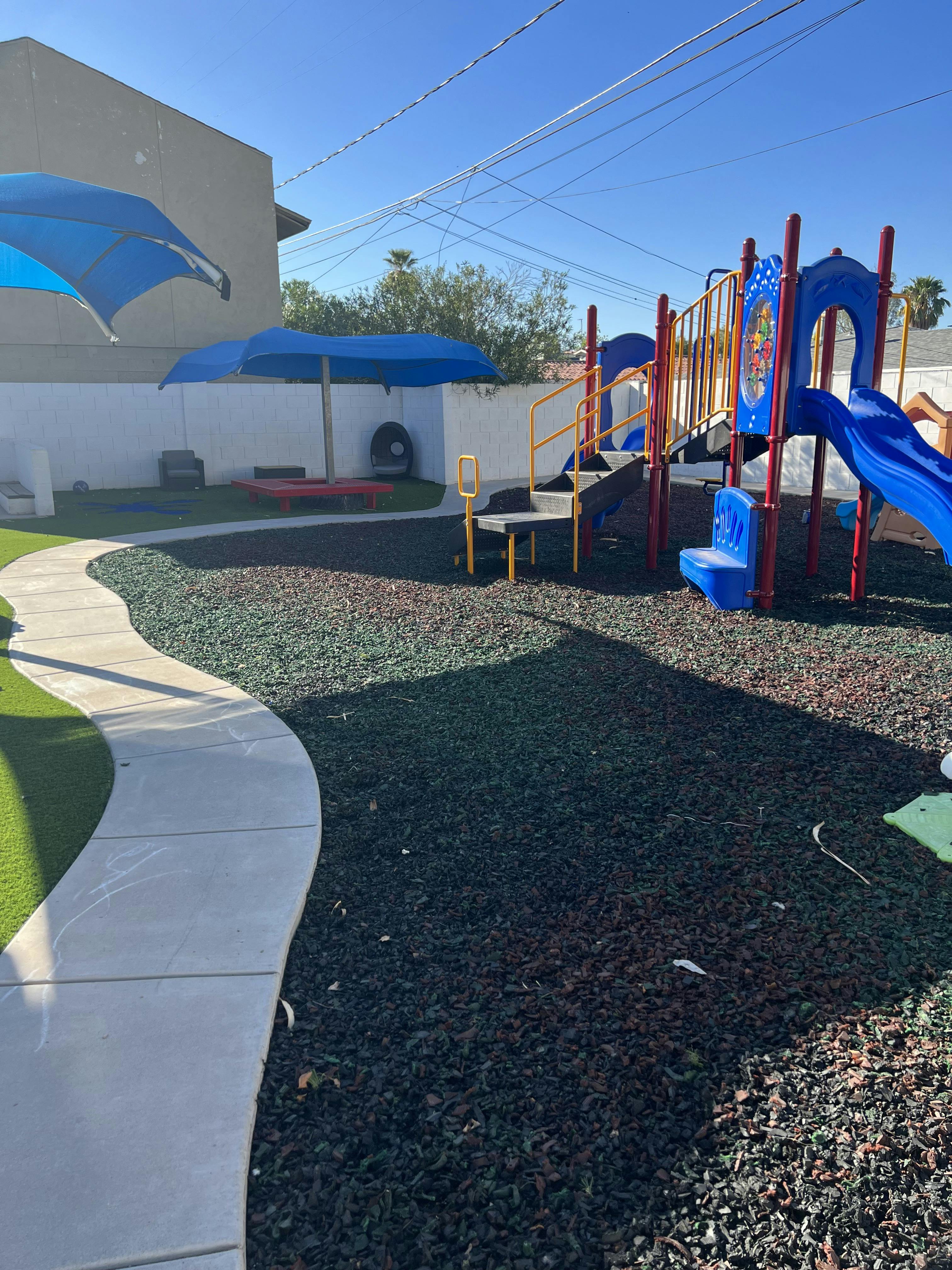 Playground with blue slides and shade structures