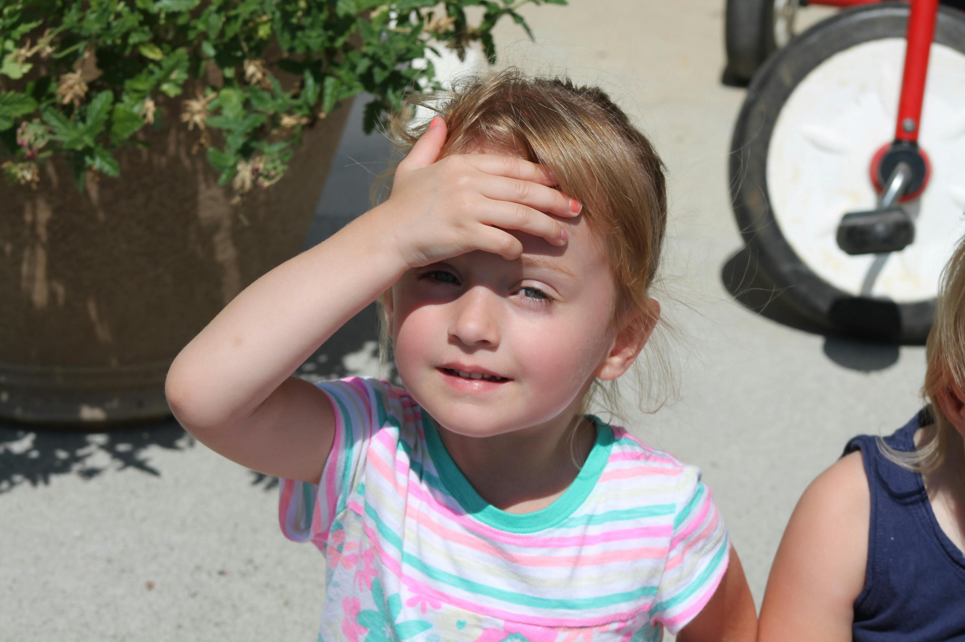 Child with hand on forehead