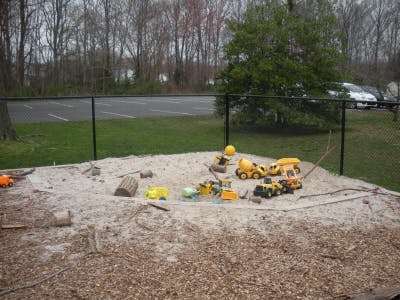 Toy construction vehicles in a sandbox