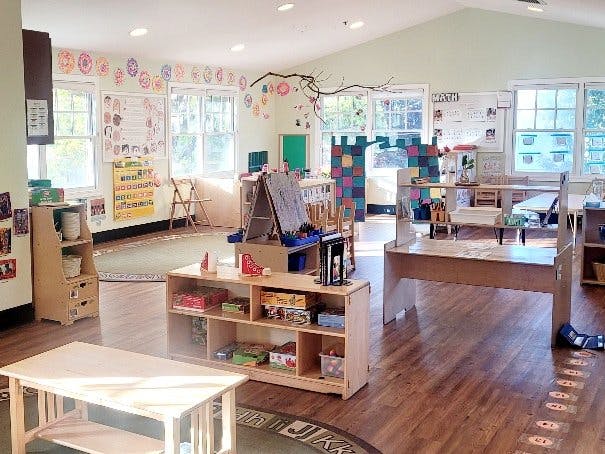 A colorful classroom with natural light and various learning stations