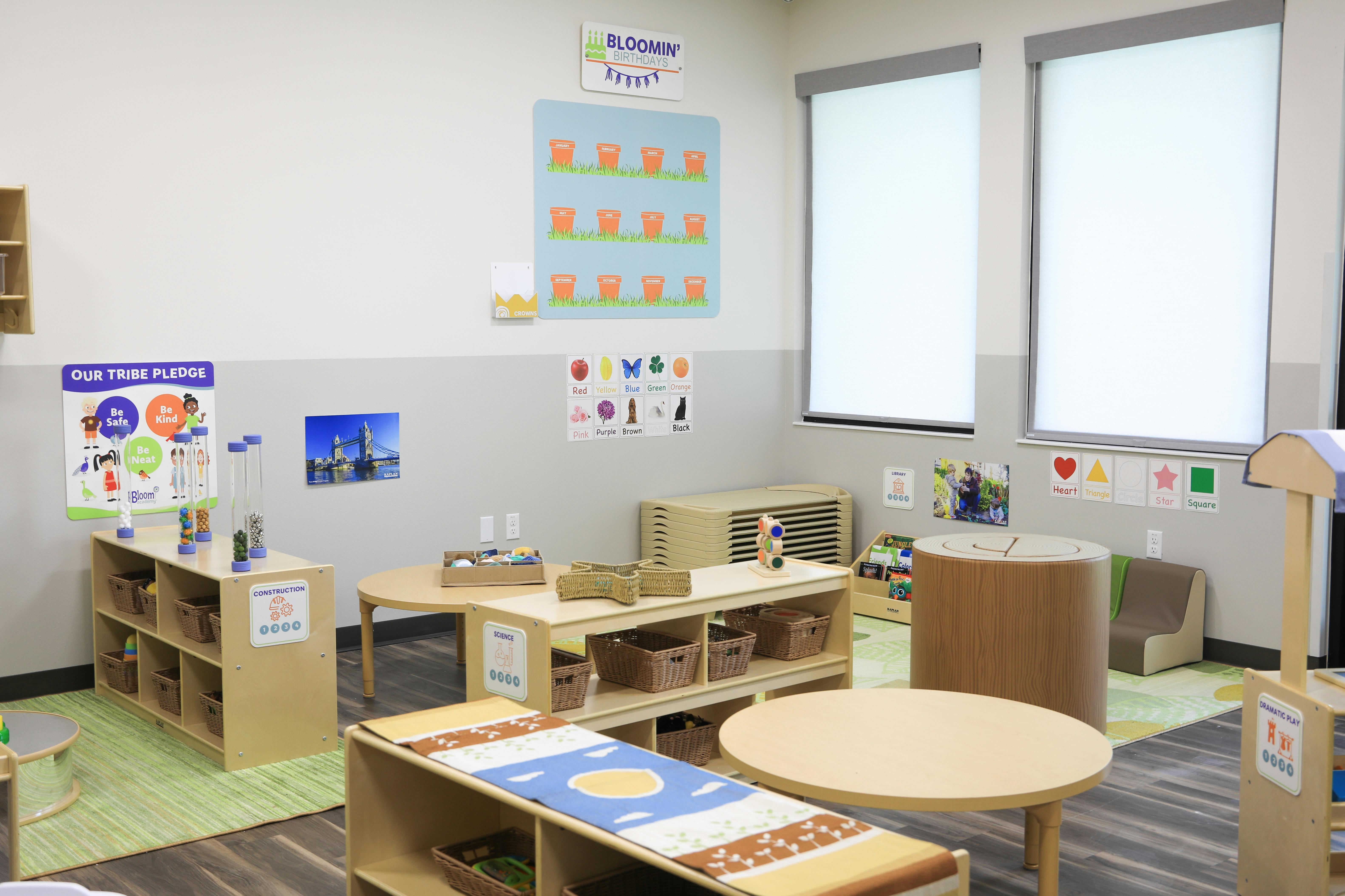Classroom with tables, shelves, and posters on the walls