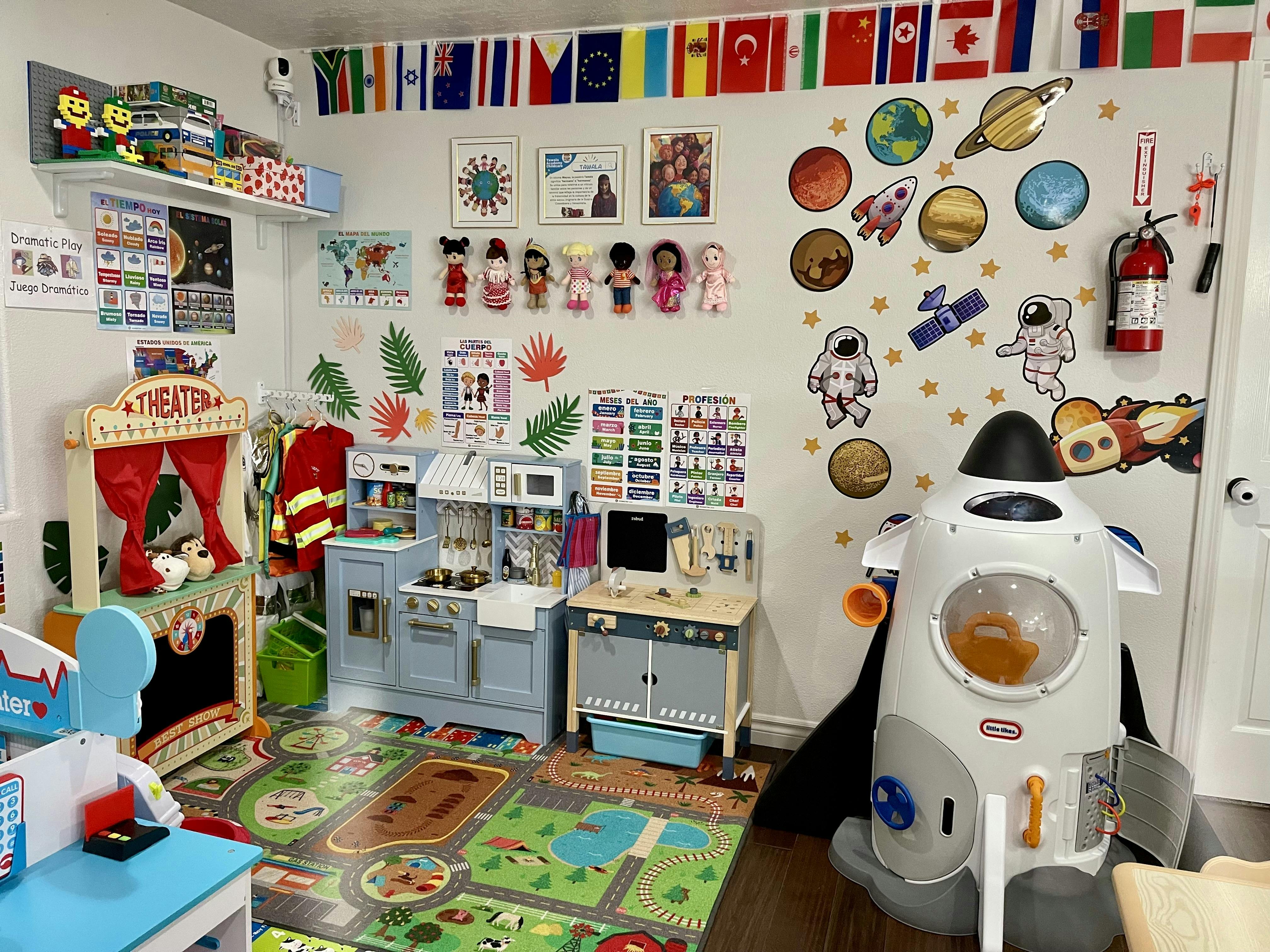 Playroom with a toy kitchen, puppet theater, and space-themed wall decorations