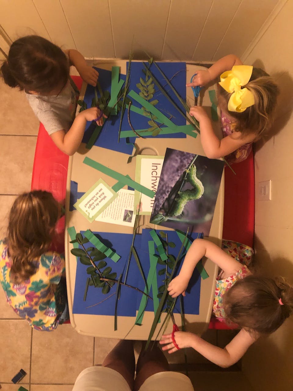 Four children doing a craft activity at a table