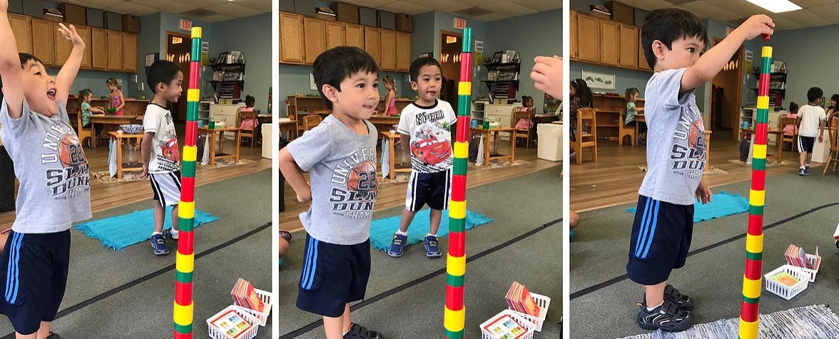 Child building a tall tower with colorful blocks