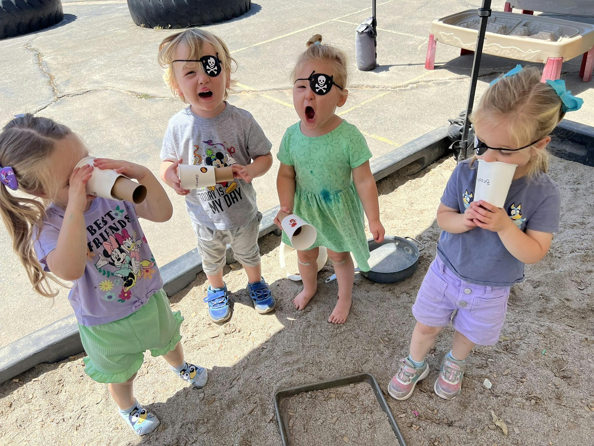 Four children playing, two wearing pirate eye patches