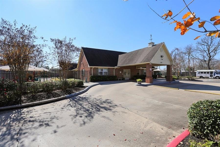 Exterior of a brick building with a covered entrance and a driveway
