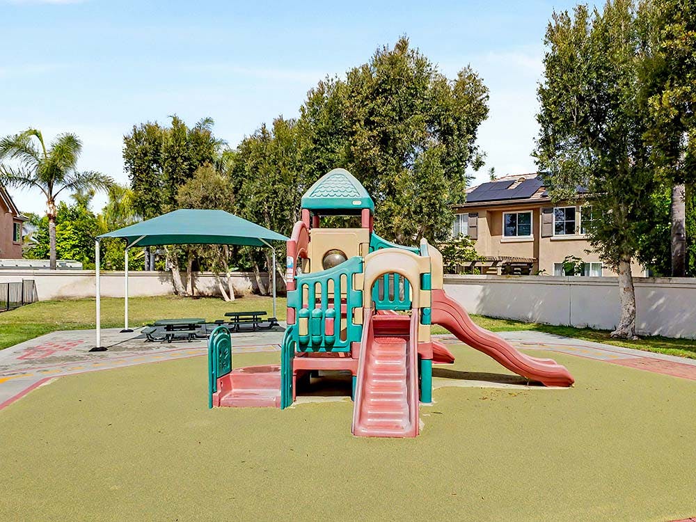 Colorful playground with slides and a climbing structure on green ground