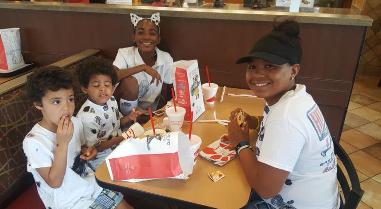 Four people eating at a table in a restaurant