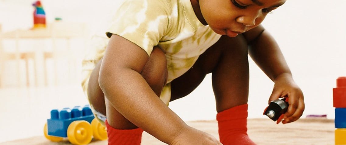 Child playing with toys on the floor