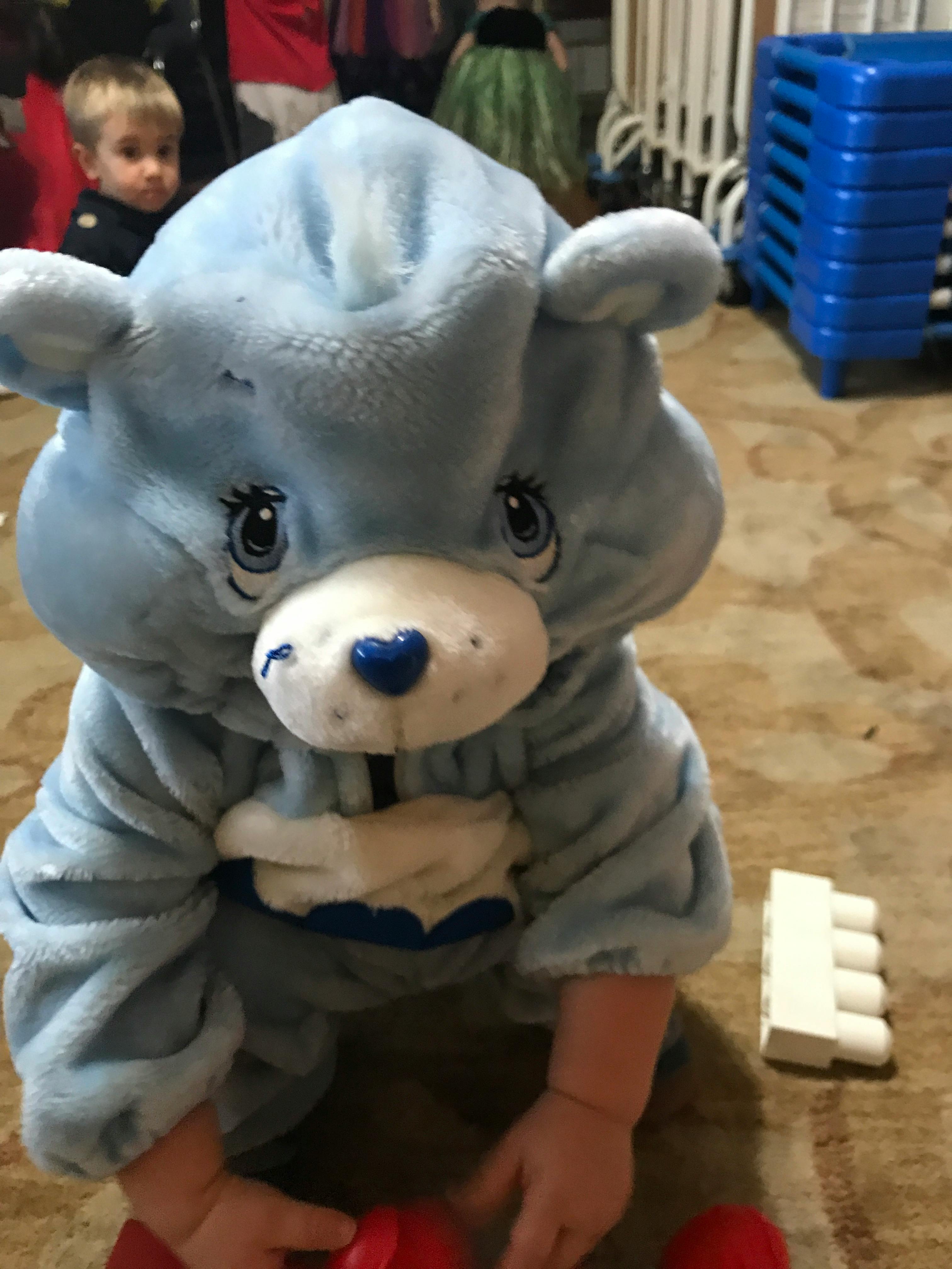 Child in a blue bear costume