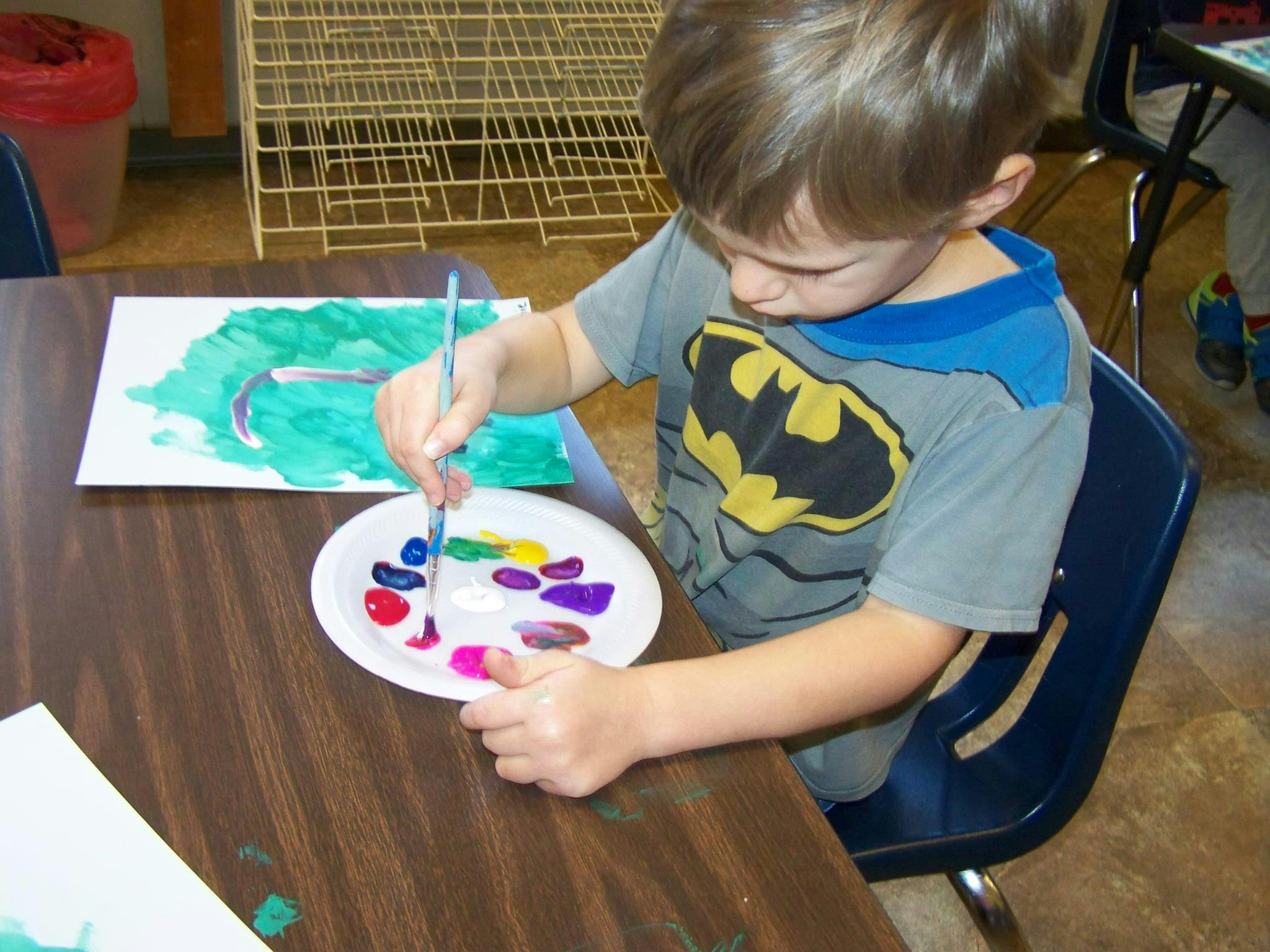 Child painting at a table