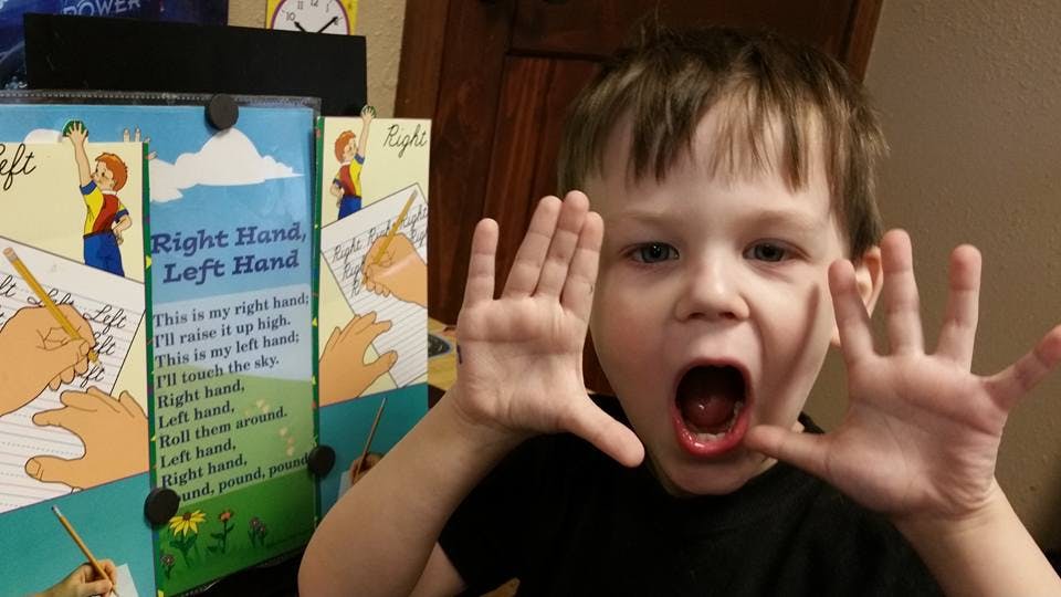 Child with mouth open and hands up next to a book titled "Right Hand Left Hand"