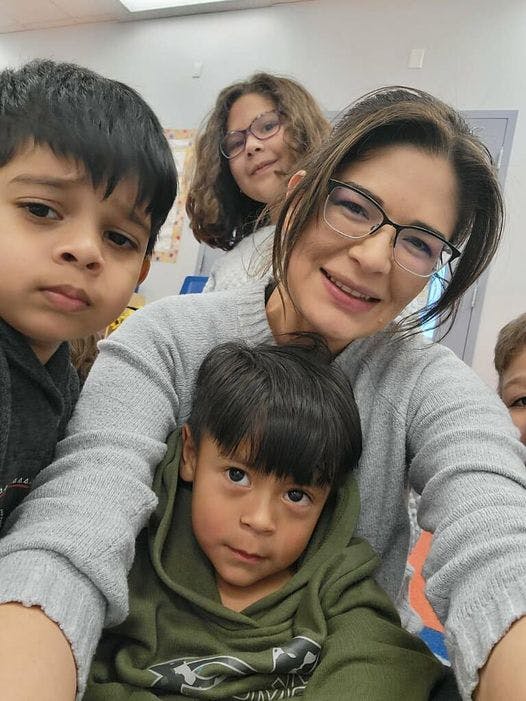 Adult and three children posing for a photo