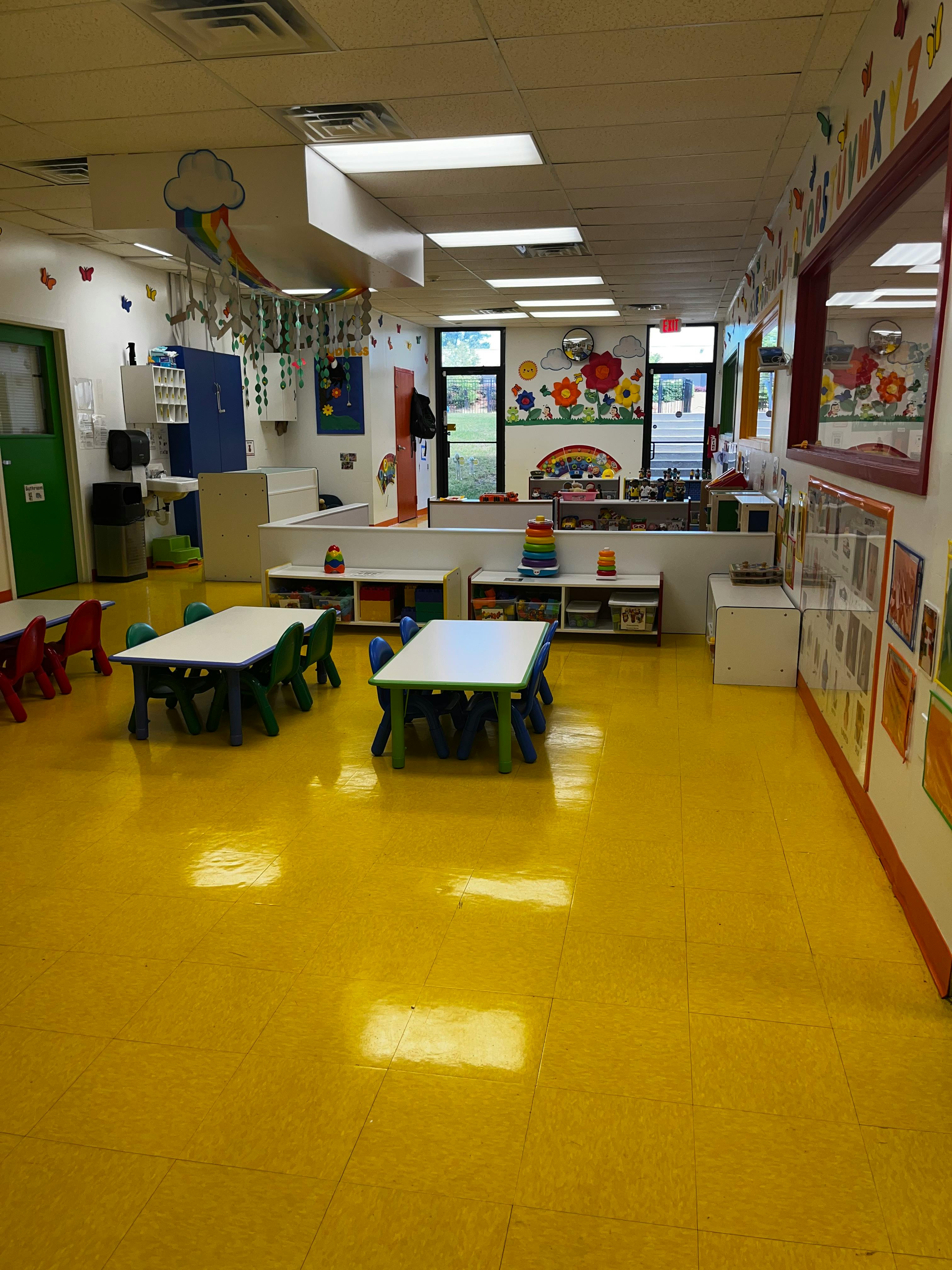 Empty classroom with small tables and chairs