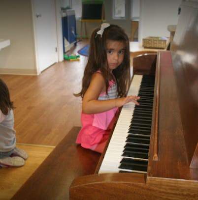 Child playing a piano