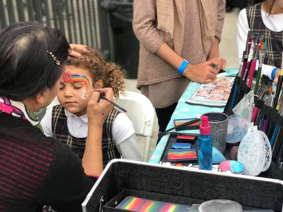 Person painting a child's face