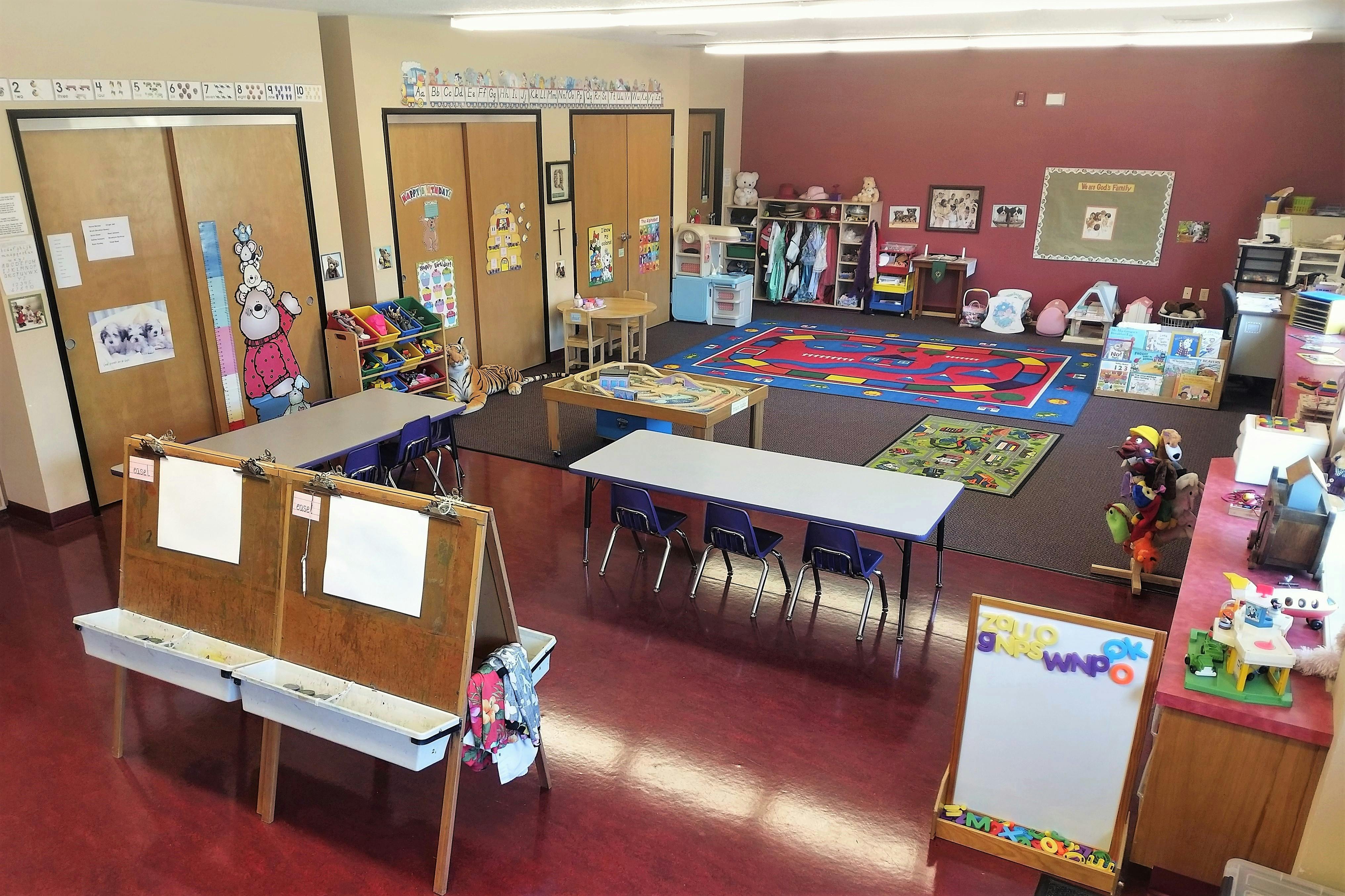 Classroom with tables, chairs, and play areas