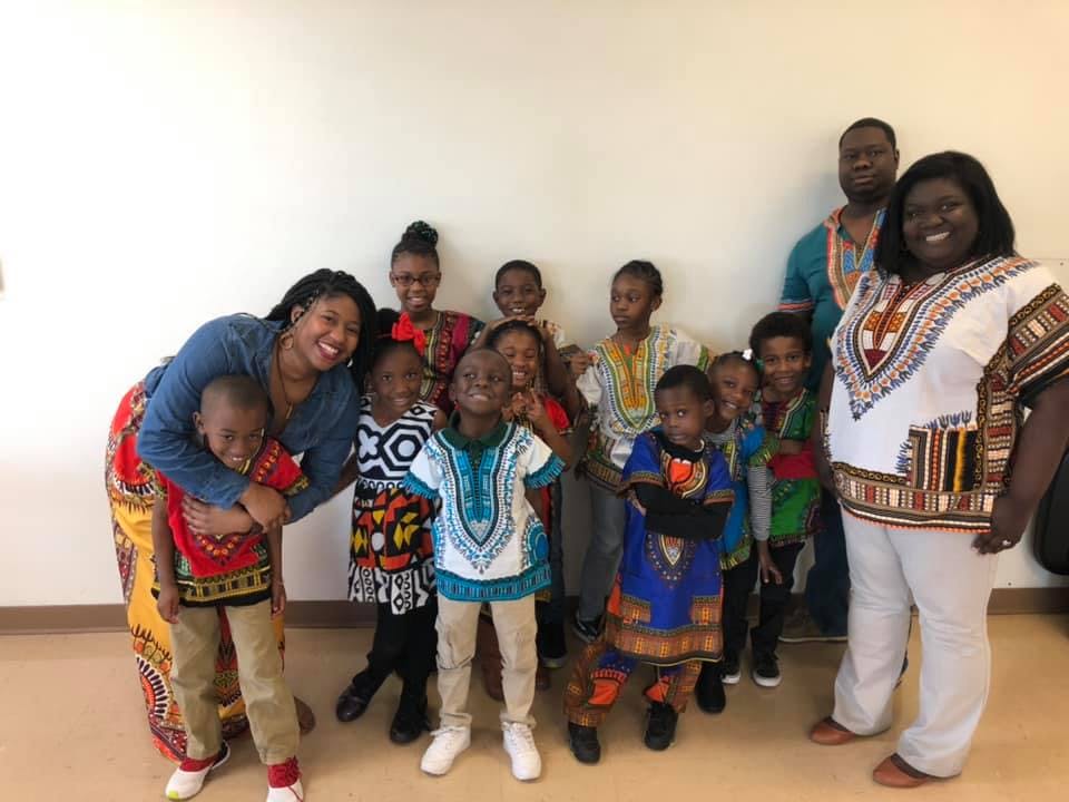 Group of adults and children posing for a photo