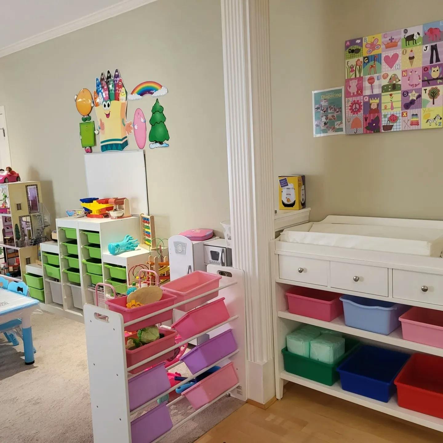 Child's room with toys, storage bins, and a changing table