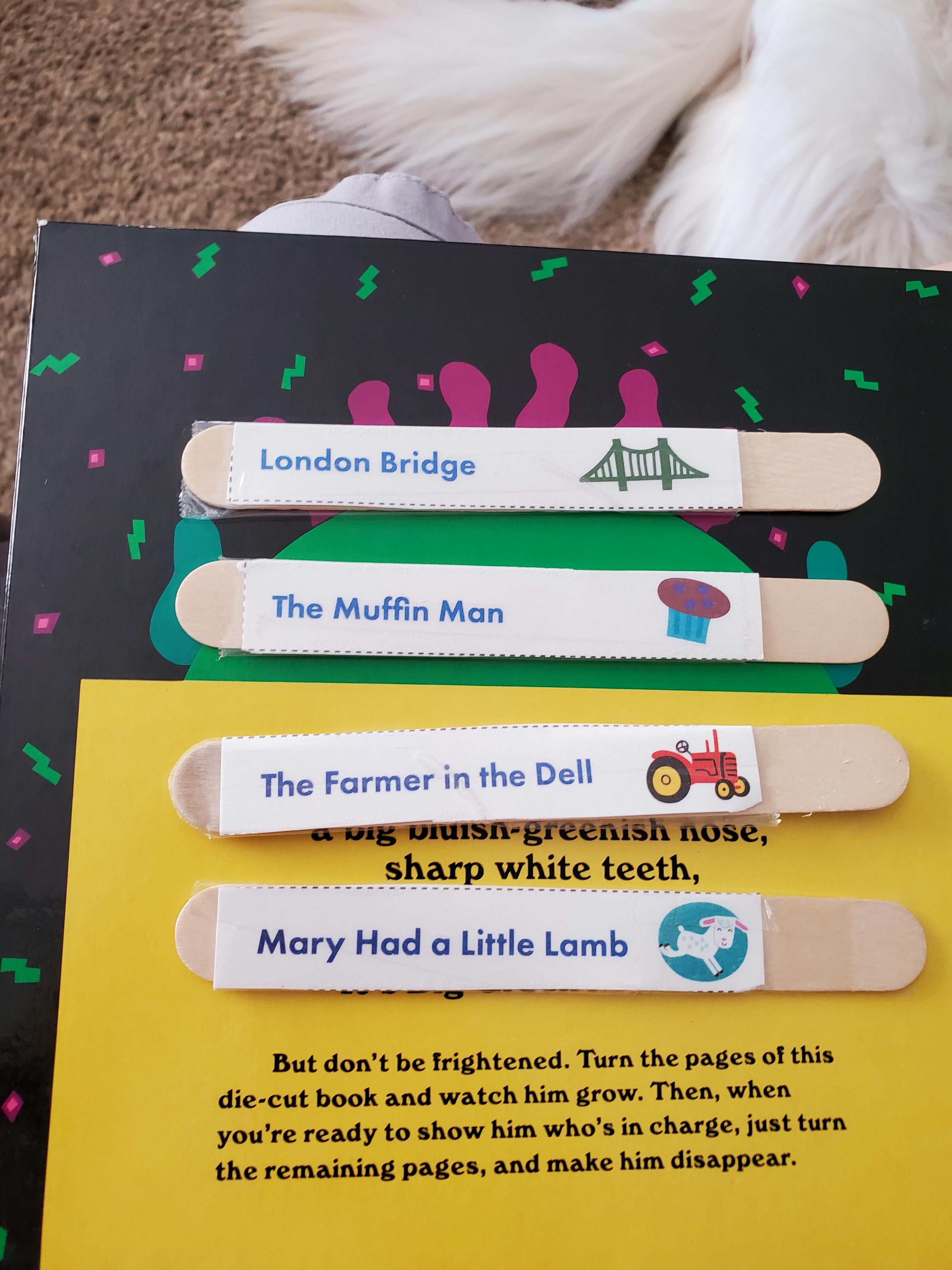 Craft sticks with nursery rhyme titles and illustrations