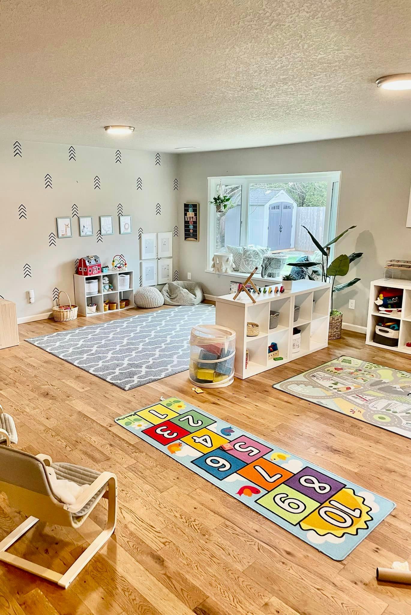 Playroom with a hopscotch rug and other play items