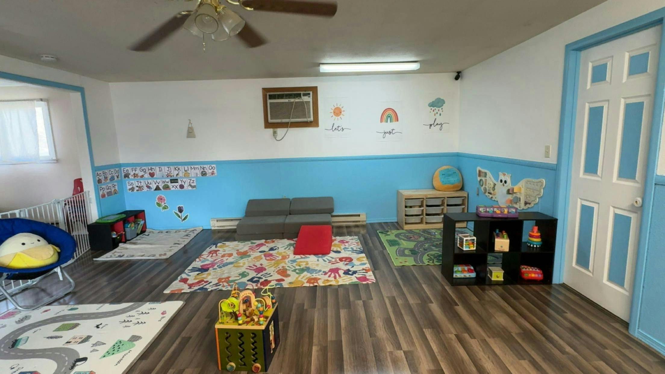 Playroom with colorful rugs and toys