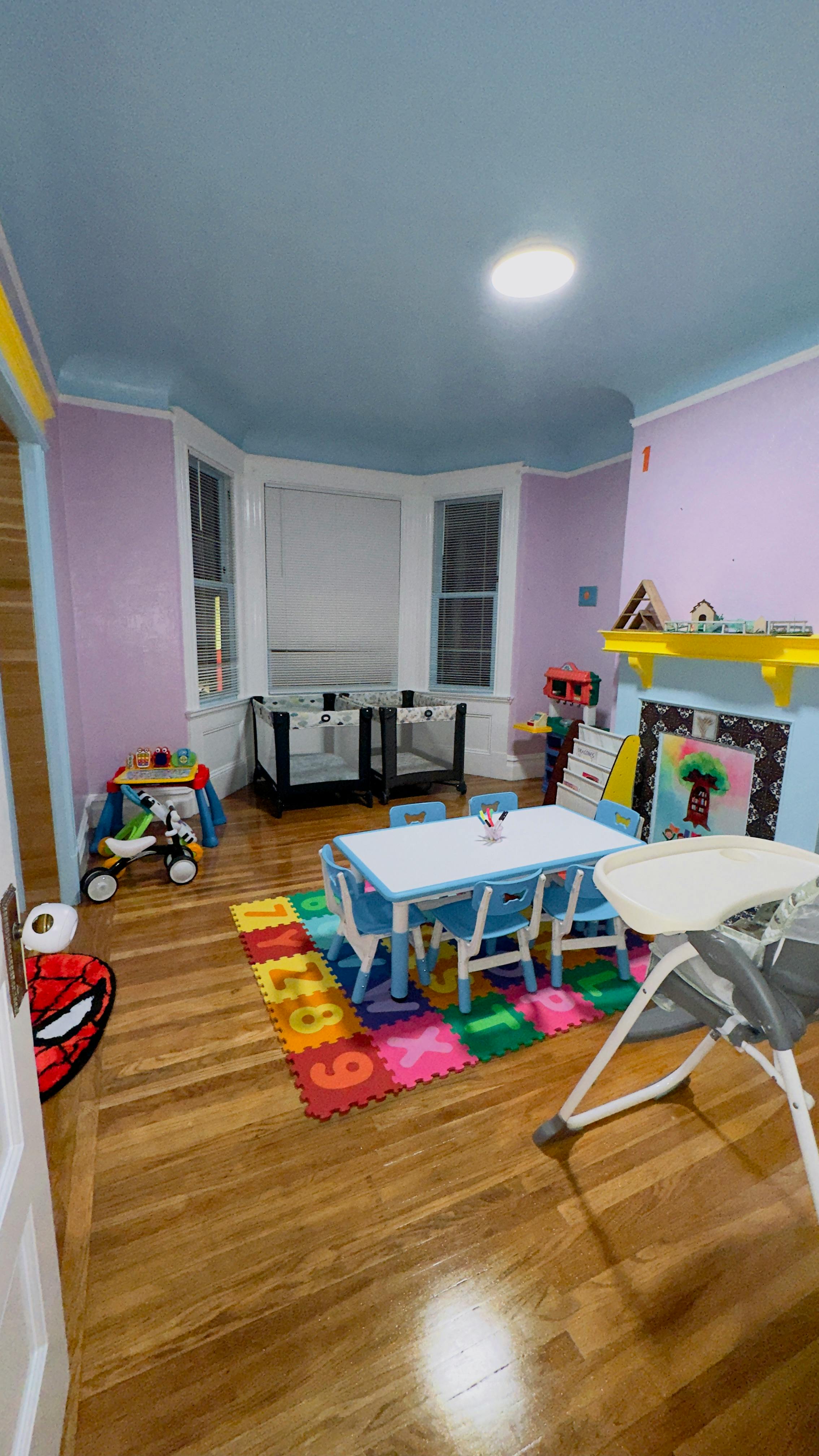 Children's playroom with a small table and chairs on a number mat