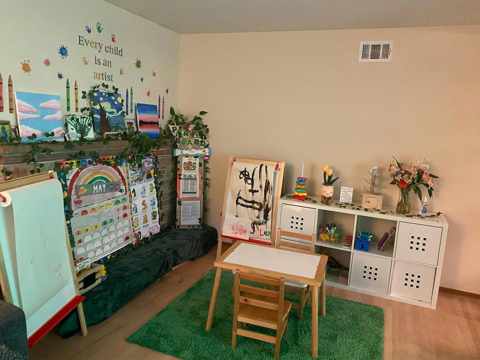 Children's learning corner with art easels, a small table, and educational decor