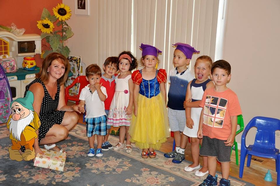 Adult and children in costumes posing for a photo