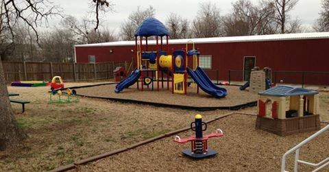 Outdoor playground with slides, swings, and play structures