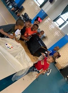 Children painting at a table