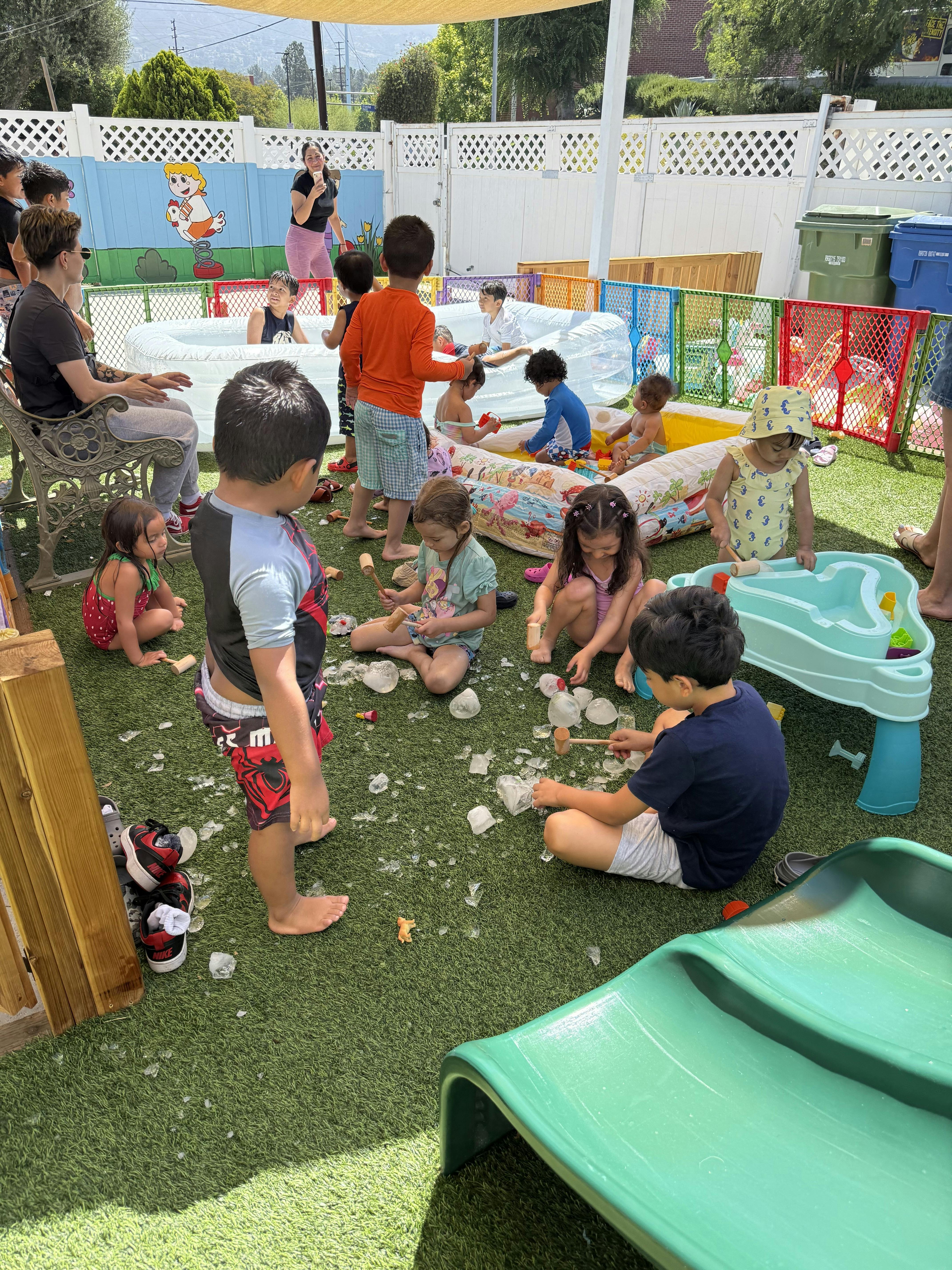 Children playing with ice and water in an outdoor play area