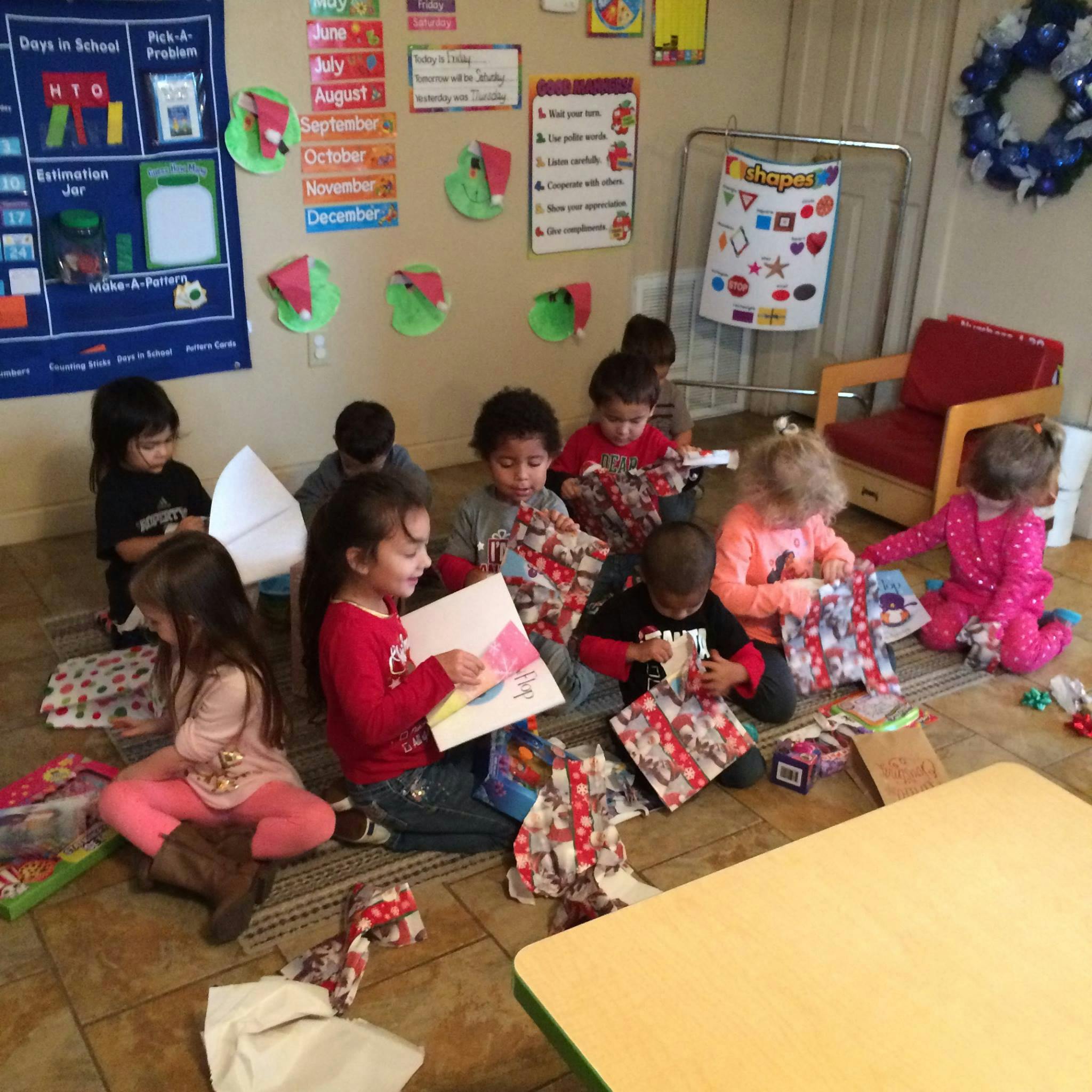 Children opening gifts in a classroom