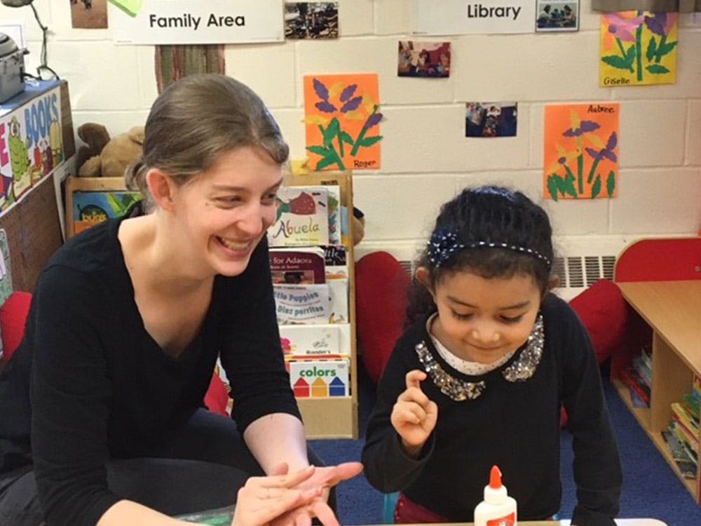 Adult and child interacting in a classroom