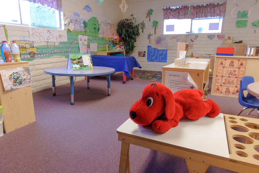 Red stuffed dog on a table in a classroom