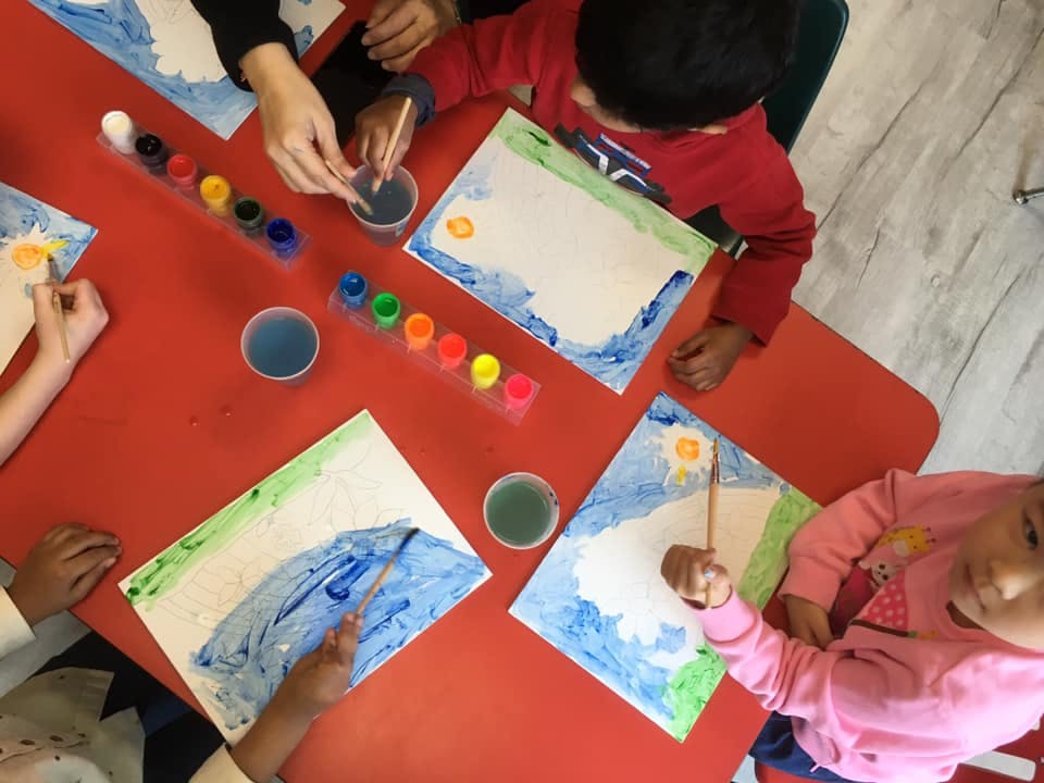 Children painting at a table