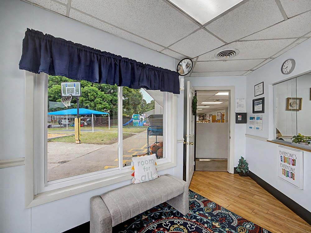 Indoor view from a room looking out a window to an outdoor play area