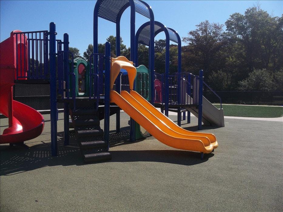 An outdoor playground with slides and climbing structures
