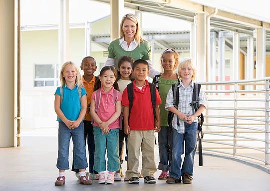 Adult and group of children standing together