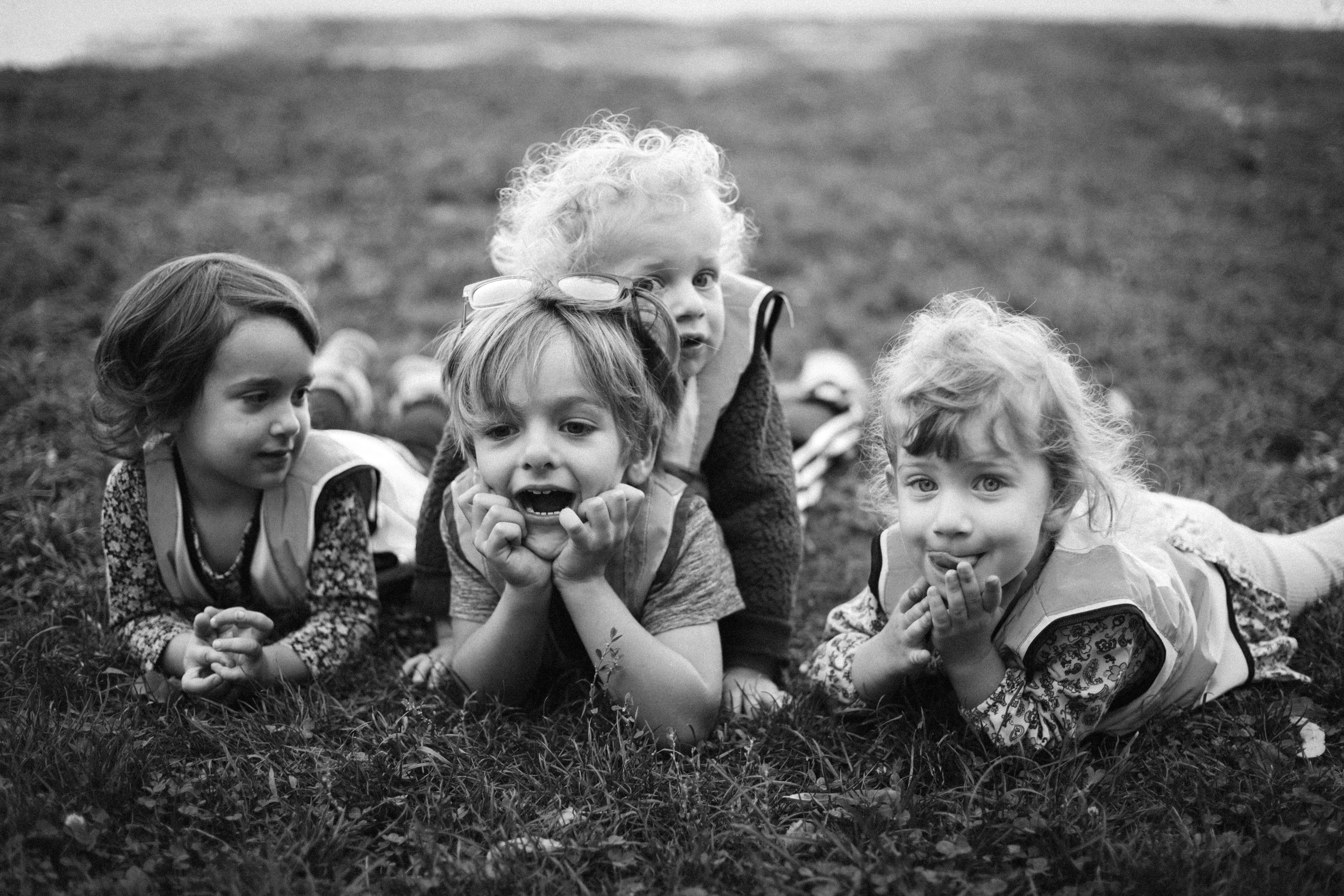 Four children lying on grass