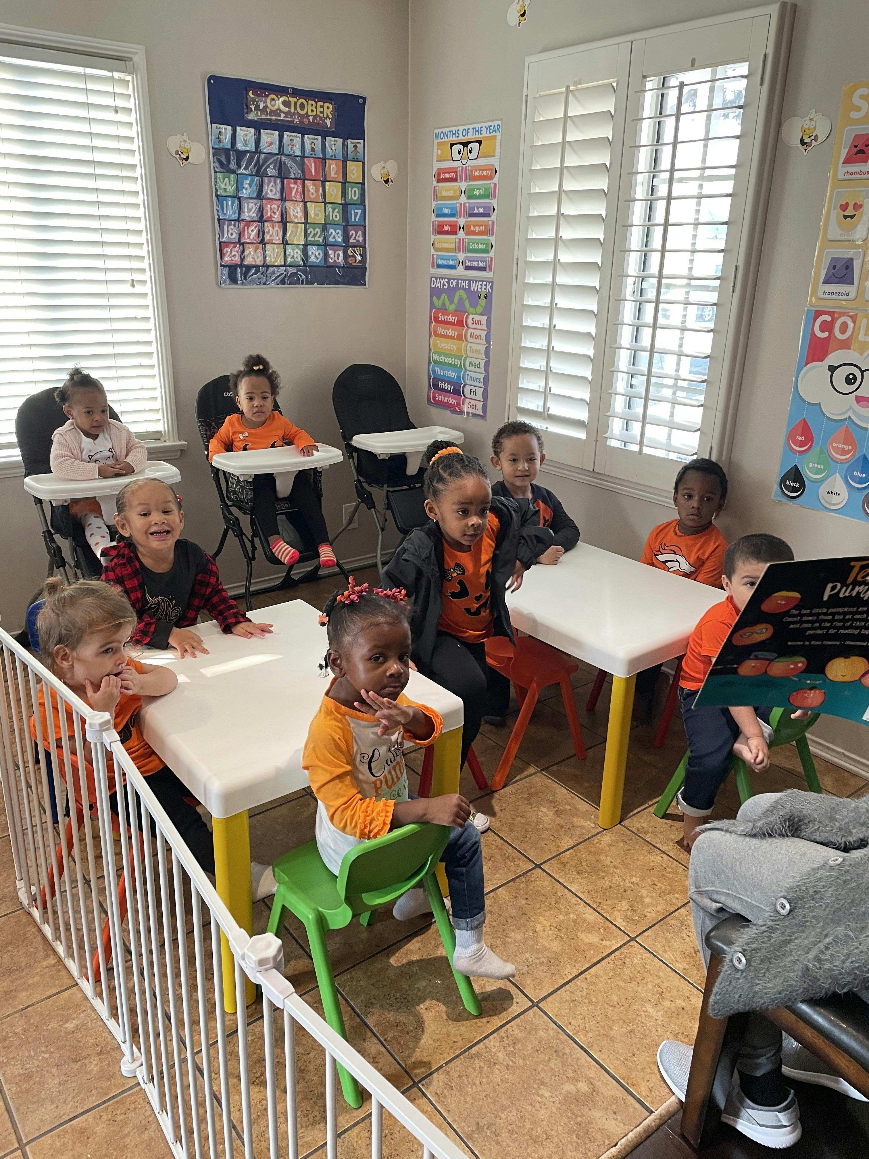 Children sitting at tables in a classroom