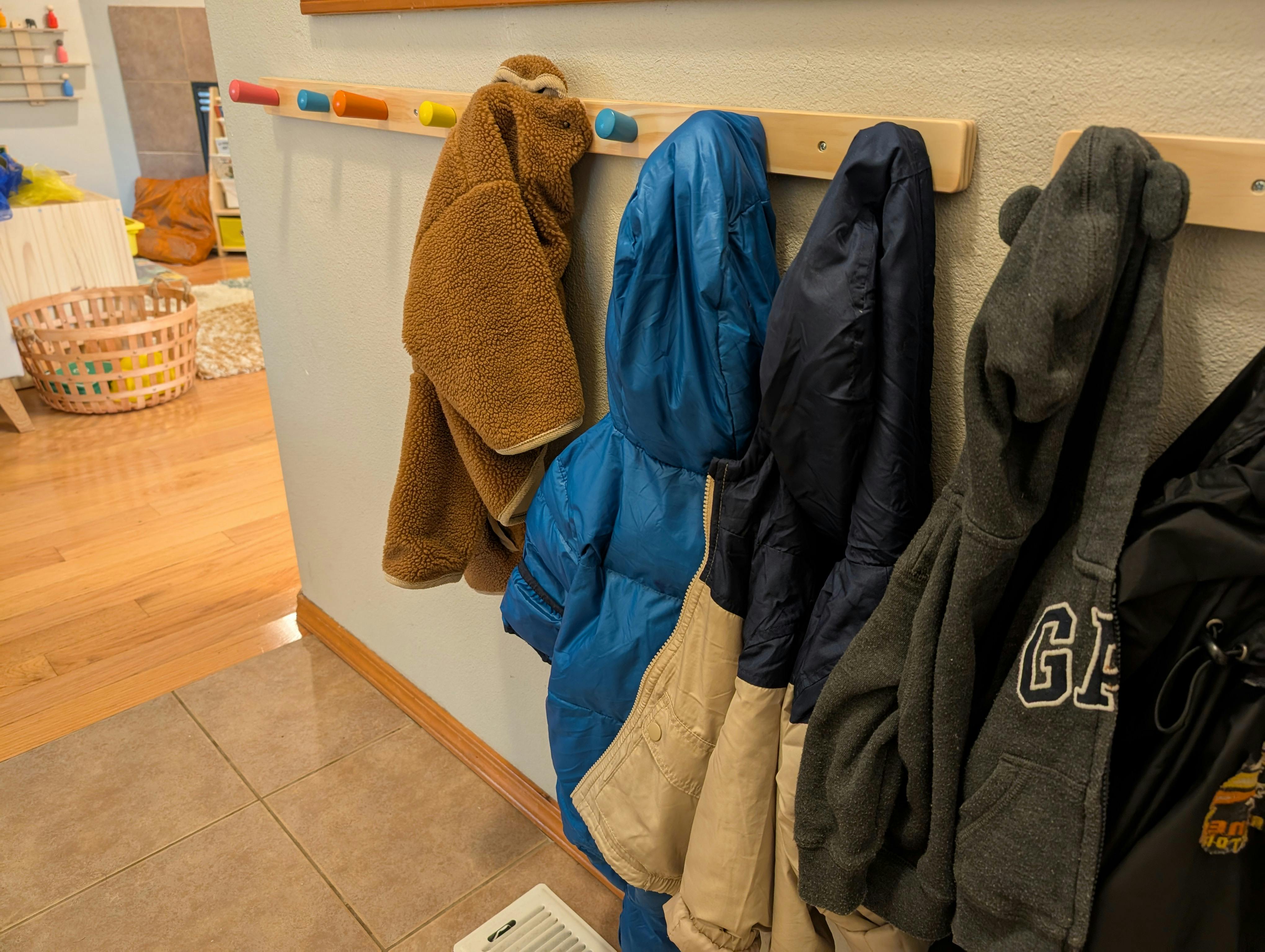 Coats hanging on hooks in a hallway