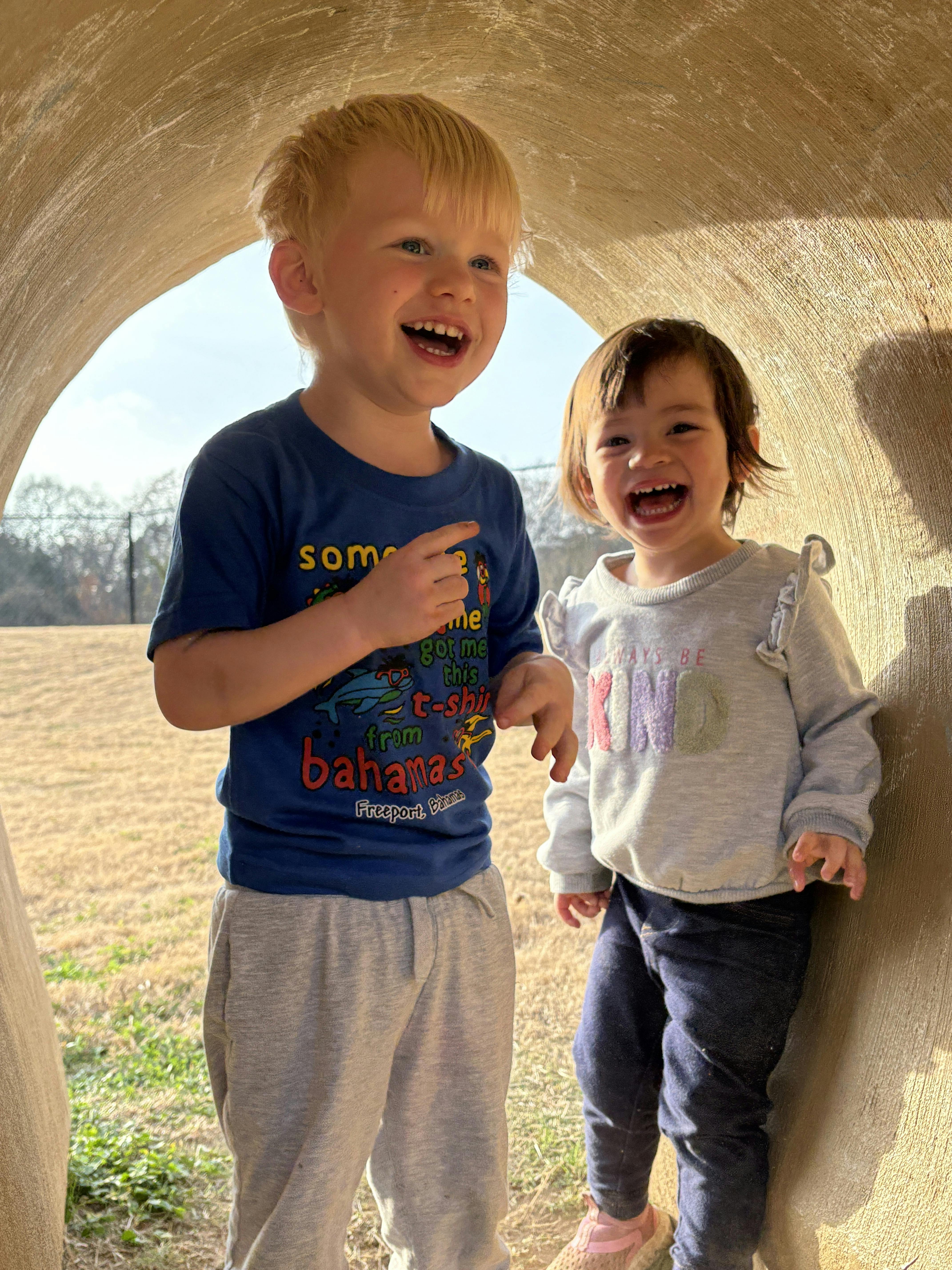 Two children playing in a tunnel