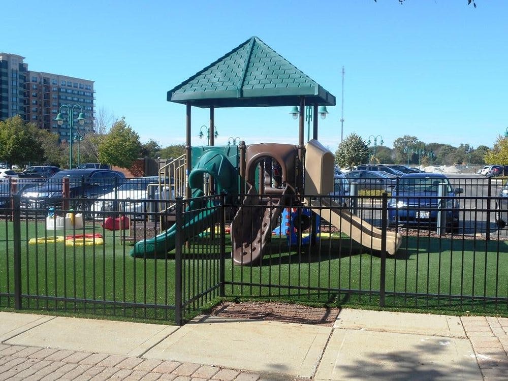Playground with slides and climbing structure on artificial turf