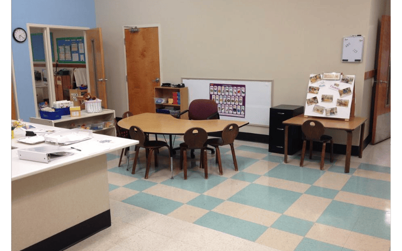 Empty classroom with small tables and chairs